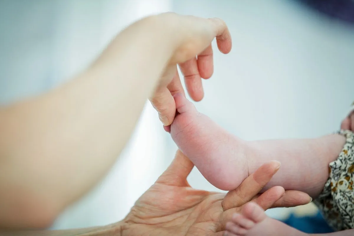 Karen carrying out baby reflexology on a babies foot