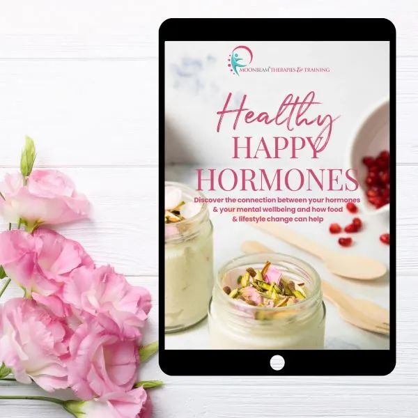 Healthy Happy Hormones ebook on a tablet background. With 5 pink carnations next to it